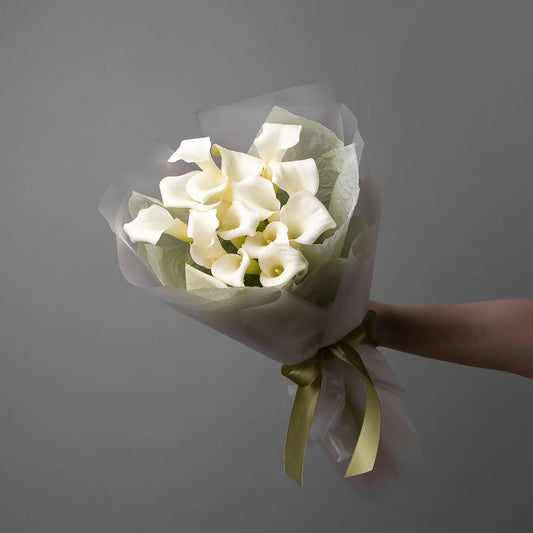 Bouquet of 16 white calla lilies with greenery