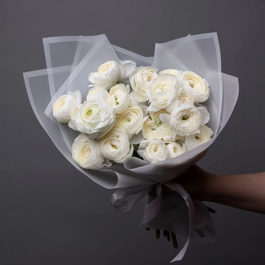 Bouquet of 24 white ranunculus flowers with greenery